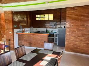 a kitchen with a dining table and a refrigerator at Hotel El Bohio in Guaduas