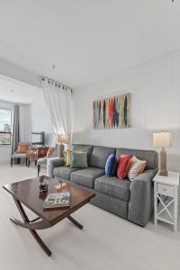 a living room with a couch and a table at ORCHID SUITES - Historic Palm Beach Hotel Condominium in Palm Beach