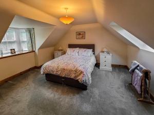 a bedroom with a large bed in a attic at South Lodge in Banchory