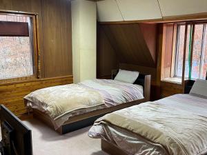 Postel nebo postele na pokoji v ubytování Forest Inn Sangoro