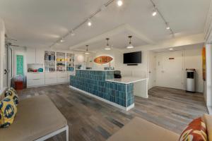 a large kitchen with white cabinets and a blue tile floor at Beach House Dewey in Dewey Beach