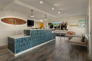 a lobby of a store with a bench and a counter at Beach House Dewey in Dewey Beach