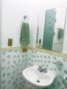 uma casa de banho com um lavatório e um espelho em Luminoso y Acogedor Apto en Casco Viejo c/balcón na Cidade do Panamá