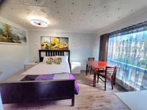 a bedroom with a bed and a desk and a table at Renovated Cozy Bedroom with Private washroom in Toronto