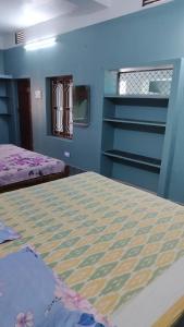 a bedroom with two beds and a window at Gourinandan lodge in Puri