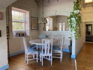 a dining room with a table and chairs at Villa Jarrow in Christ Church