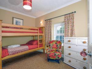 a bedroom with a bunk bed and a chair at Trefrane House-qc1119 in Roch