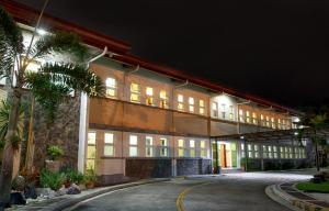 a large building with a lot of windows at night at La Piazza Hotel and Convention Center Inc. in Legazpi