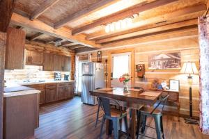 a kitchen with a table and chairs and a refrigerator at Charleys Cabin in Nashville