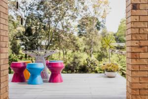 a group of colorful vases sitting on a patio at Pet and family friendly- with its own lake and 3 mins from town! in Maleny