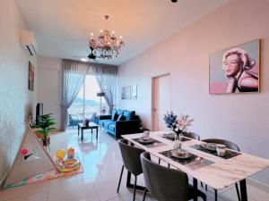 a dining room and living room with a table and chairs at Ipoh Town Family Suite w Balcony[8pax]FREE Parking in Ipoh