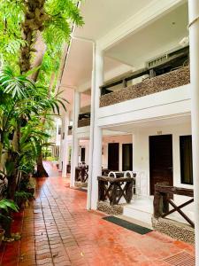 a courtyard of a building with plants and a sidewalk at White House Beach Resort in Boracay