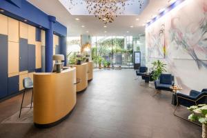 an office lobby with a row of desks and chairs at Renaissance Paris Arc de Triomphe Hotel in Paris