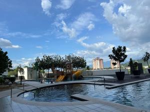 a swimming pool with a playground in a park at Ipoh Town Family Suite w Balcony[8pax]FREE Parking in Ipoh