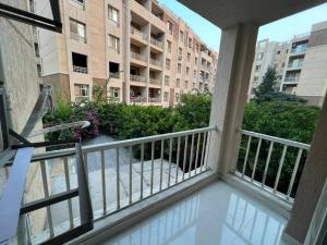 a balcony with a view of a building at High quality apartment Madinty in Cairo +8 photos