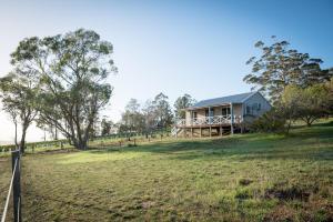 a house on top of a field with a fence at The Sleeping Lady Private Retreat in Porongurup