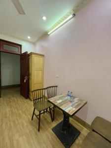 a room with a table and two chairs and a door at The Mountain View Homestay in Ninh Binh