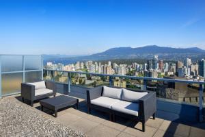 a balcony with chairs and a view of a city at Sheraton Vancouver Wall Centre in Vancouver
