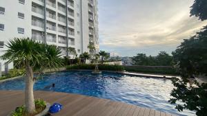 a swimming pool in front of a building at Japanese Zen Room Citra Plaza Nagoya Batam - by A-Rooms in Nagoya