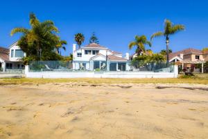 a house on the beach with palm trees at Private Beach front 4bed 4bath pool and spa house in San Diego