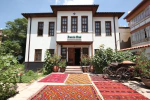 a building with colorful carpets in front of it at Konya Dervish Hotel in Konya