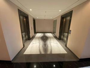 an empty hallway with a wooden floor in a building at Cozy Studio Unit @Ciputra World Surabaya in Surabaya