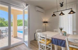 a kitchen and dining room with a table and chairs at Villa Florami in Pula