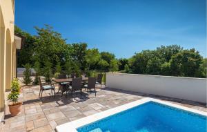 a patio with a table and a swimming pool at Villa Florami in Pula