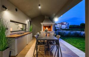 cocina con mesa, sillas y barra en Villa Nobu, en Pula