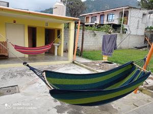 a hammock in front of a house at Hostal The Friends in Panajachel