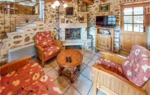 a living room with a couch and a table and a fireplace at Gite Rural Le Couvent in Riom-ès-Montagnes