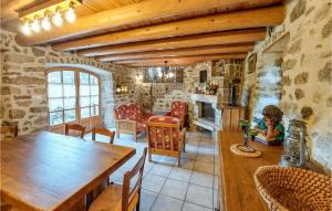 a kitchen with a wooden table and a dining room at Gite Rural Le Couvent in Riom-ès-Montagnes