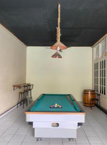 a ping pong table in a room with a pool table at Sentosa Lodge in Kampungdurian