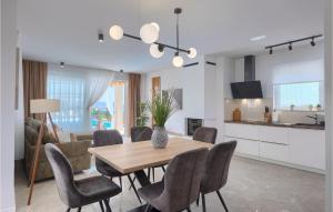 a kitchen and dining room with a table and chairs at Villa Veduta in Pula