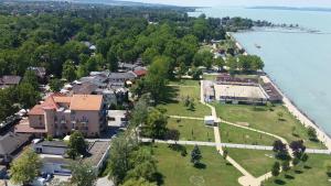 an aerial view of a house next to the water at Hotel La Riva in Siófok