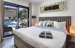 a bedroom with a large bed and a pool at Villa D&V in Veli Vrh