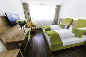 a hotel room with a bed and a table at Hotel Rheingold in Gailingen