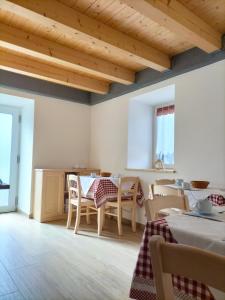 uma sala de jantar com uma mesa e cadeiras e tectos em madeira em Cà Soldati em Campi