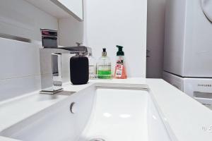 a white kitchen counter with alcohol bottles on it at Southbank 23F 1BR 4Guest City Skyline Pool & Gym in Melbourne +25 photos