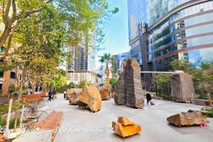 a sculpture of rocks and benches in a city at Southbank 23F 1BR 4Guest City Skyline Pool & Gym in Melbourne