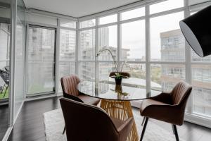 a dining room with a table and chairs and windows at The Perfect Getaway in Toronto