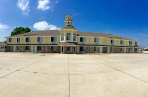 a large yellow building with a tower on top at Platte Valley Inn in Columbus
