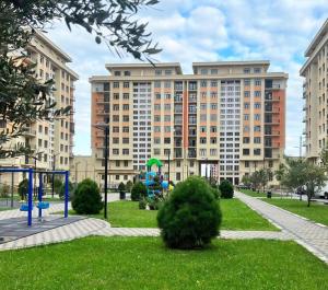 a large building with a playground in a park at Boulevard in Sumqayıt +7 photos