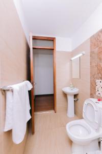 a bathroom with a toilet and a sink at Ruaka Radiance 2-Bed Escape in Ruaka