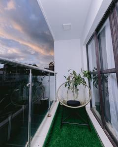 a balcony with a chair and a plant on it at Ruaka Radiance 2-Bed Escape in Ruaka