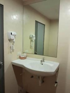 a bathroom with a sink and a large mirror at Toto Residence in Ao Nang Beach