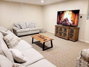 a living room with a couch and a tv at First floor Buffalo/Niagara Apt close to stadium in Depew