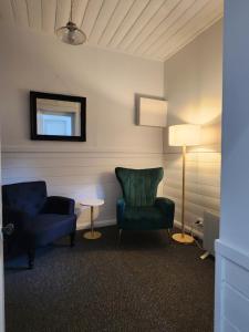 a living room with two chairs and a lamp at Daylesford - FROG HOLLOW ESTATE - The Homestead in Daylesford