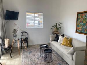 a living room with a couch and a table at vanwyksdorp accommodation - OLDE POST HOUSE in Van Wyksdorp