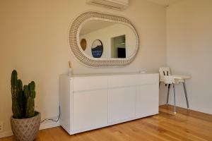 a white dresser in a room with a mirror at Torquay Retreat in Kaikoura